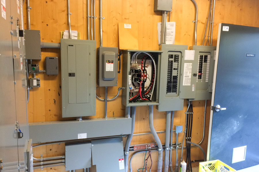 An electrical room with various electrical panels