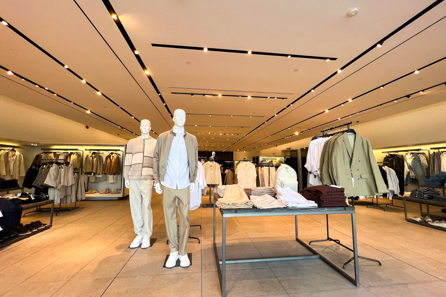 The storefront men's section of Zara, showcasing multiple small ceiling lights.